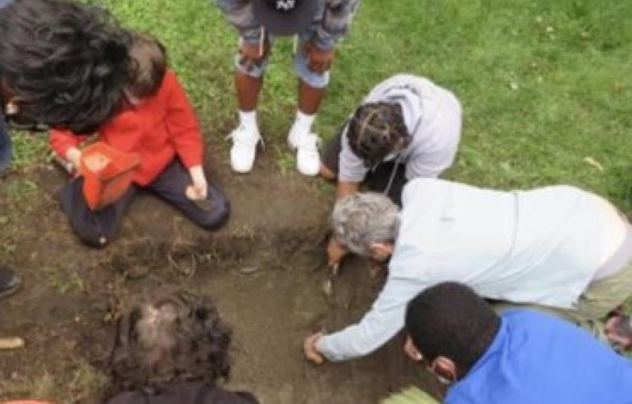 students excavating a test unit