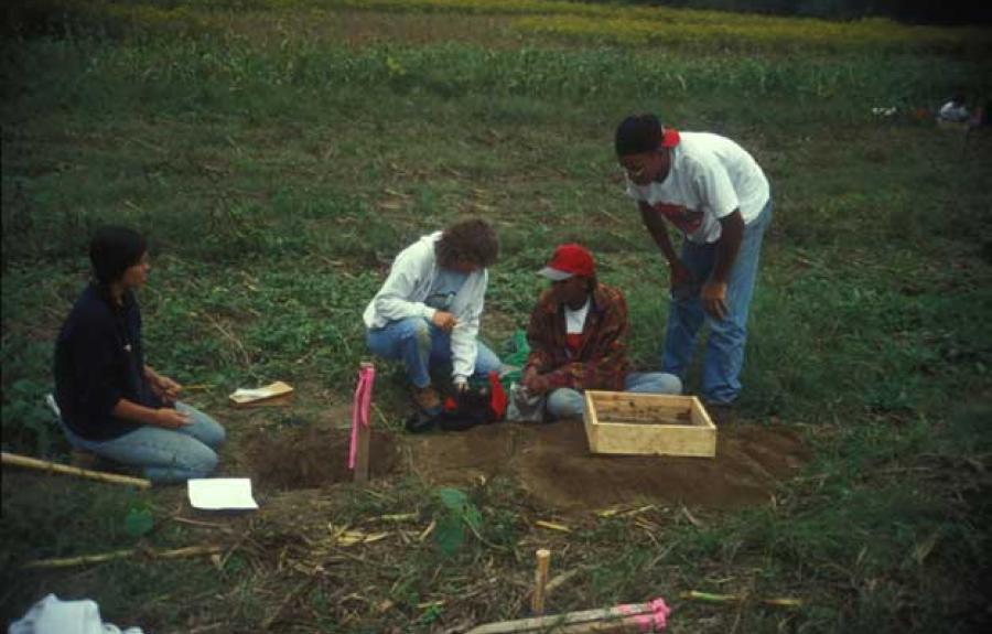 Mohawk Indian teaching assistant Susan Pacek (left) comments as Sherene Baugher (center) examines artifacts found by two students