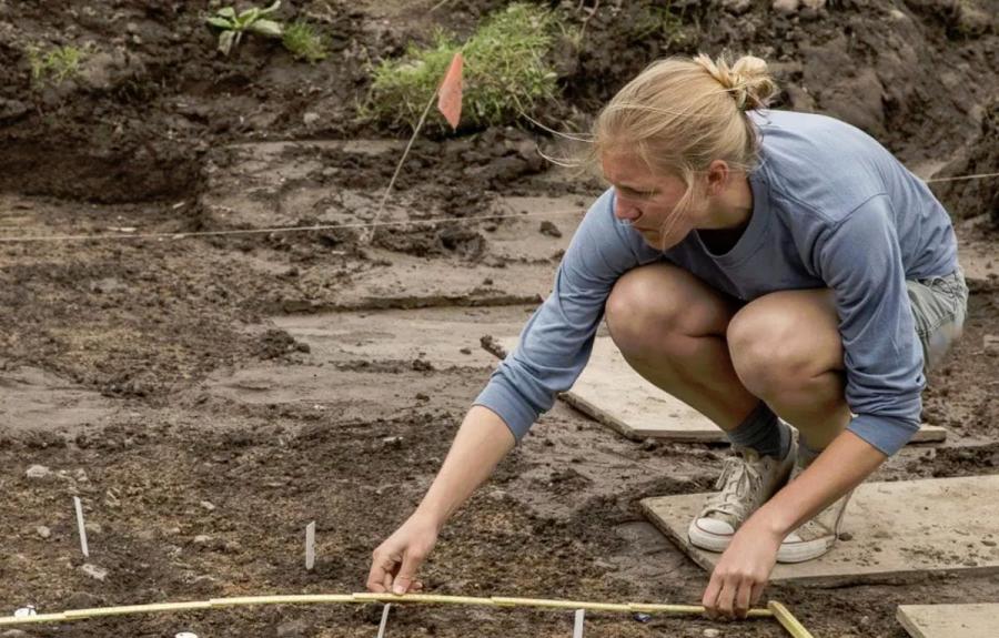 Perri Gerard-Little (completed Anthropology PhD in Spring 2017) takes measurements at the excavation site.