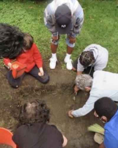 students excavating a test unit